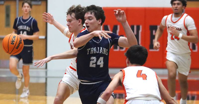 McHenry’s Dayton Warren, left, tips the ball away from Cary-Grove’s Brady Bauer in varsity boys basketball on Tuesday, Feb. 17, 2026, at McHenry High School in McHenry.