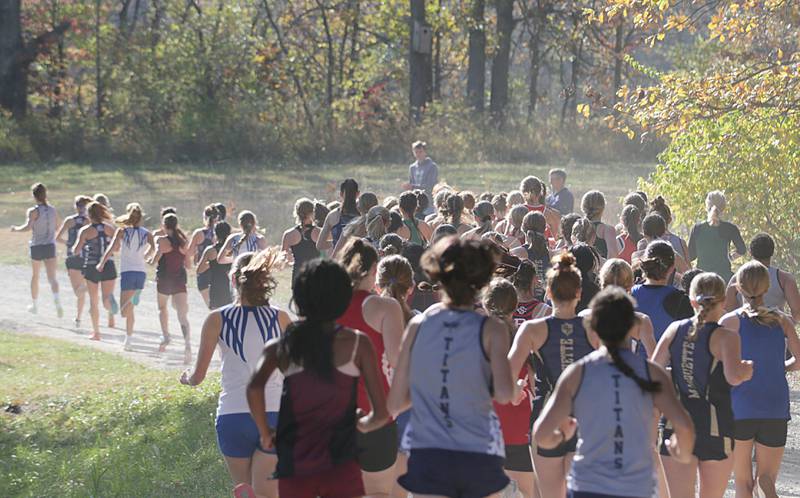 Cross Country girls begin the Class 1A Regional Cross Country race on Saturday, Oct. 22, 2022 at the Seneca FFA Farm in Marseilles.