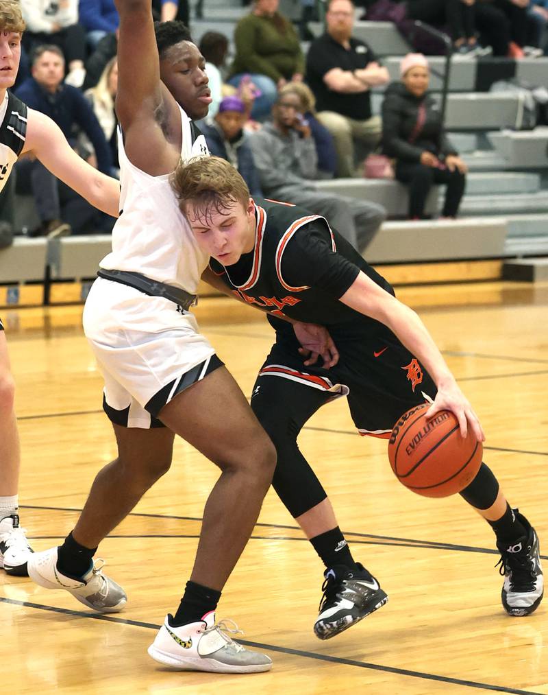 DeKalb's Sean Reynolds runs into Kaneland's Gevon Grant as he drives during their game Tuesday, Jan. 24, 2023, at Kaneland High School.