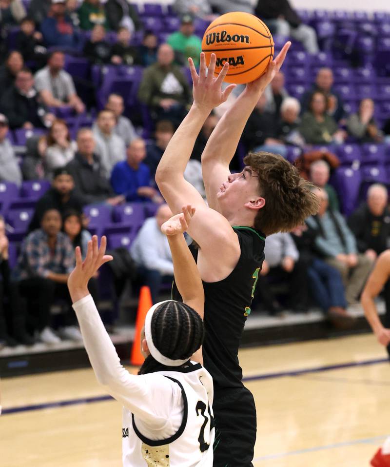 Crystal Lake South's Nick Stowasser shoots over Sycamore's Unique Shaw during their sectional semifinal game Tuesday, March 4, 2025, at Rochelle High School.