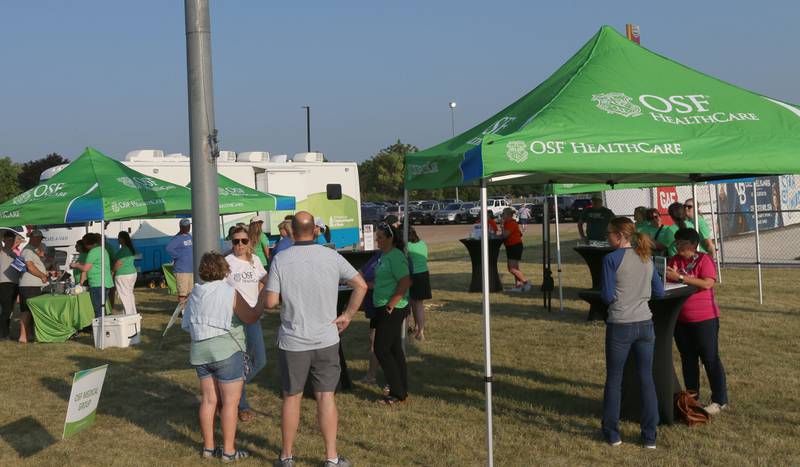 OSF Healthcare had booths with presentatives helping Illinois Valley residence with questions and services during First Responder night at the Illinois Valley Pistol Shrimp baseball game at Schweickert Stadium on Tuesday, June 20, 2023 in Peru.