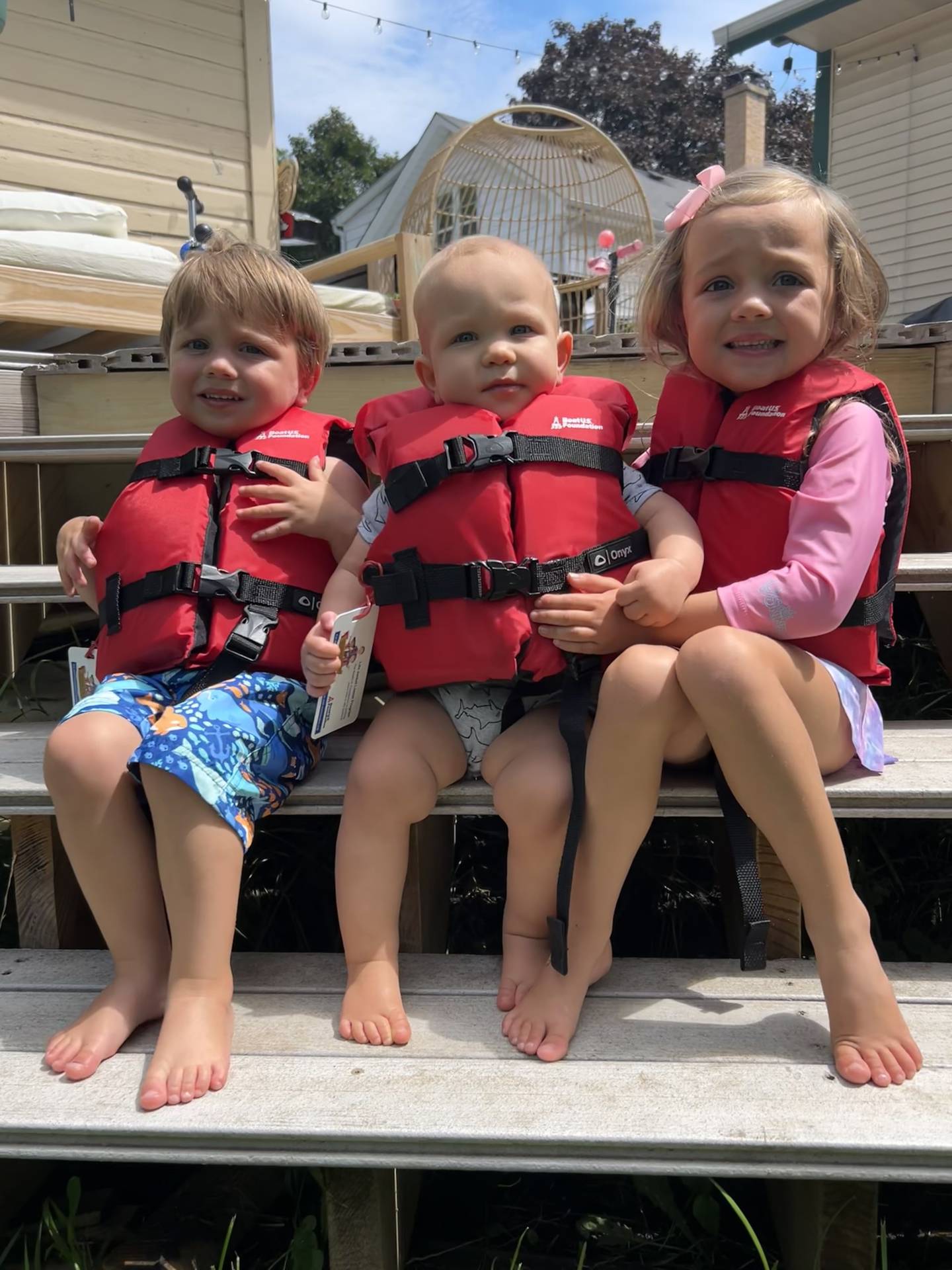 Family members of McHenry Township Fire Protection District public education coordinator Gwynne Finfrock model the life vests designed for young children and available for loan from the district during a July 2024 photo shoot.