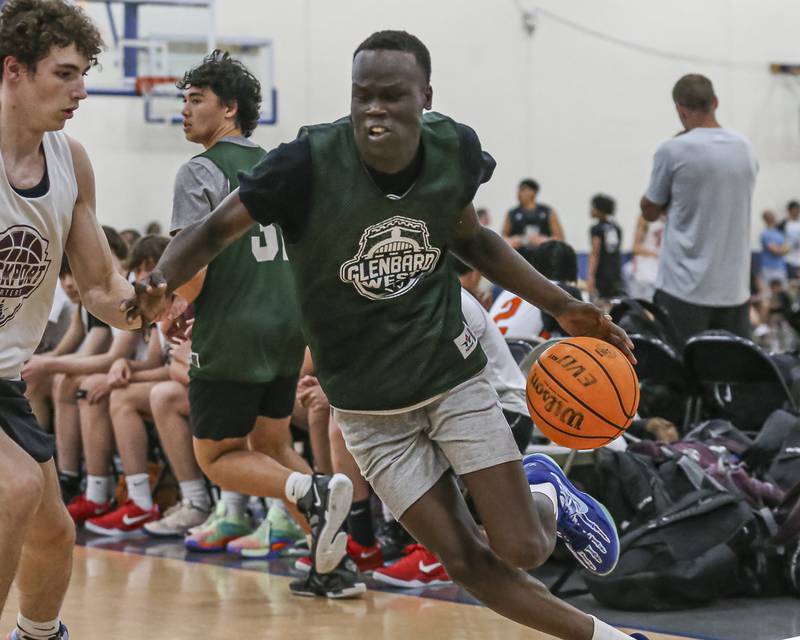 Glenbard West's Josh Abushanab drives past the defense in their Riverside-Brookfield Shootout basketball game.  June 20, 2025 in Riverside.
