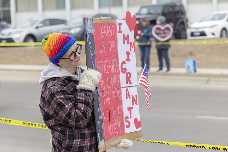 Colony Buis of Sterling displays a sign Saturday, Feb. 14, 2026, during an I Love America rally in Sterling. The rally was organized by Indivisible Sauk Valley.