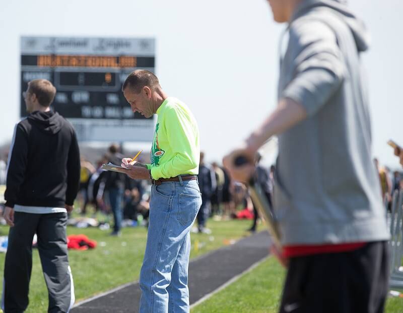 Kaneland Girls Track Coach Doug Ecker officiates the boys long jump event during The Peterson Prep Track Meet at Kaneland High School in Maple Park, IL on Saturday, April 26, 2014