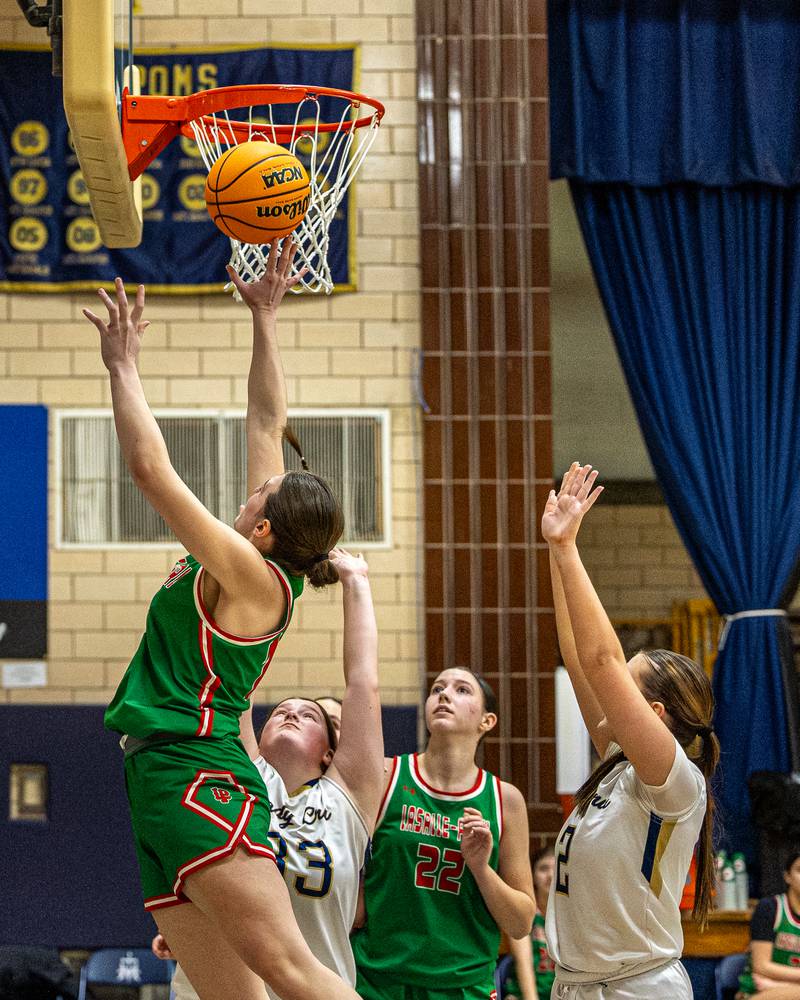 Drew Depenbrock (14) of LaSalle-Peru lays ball up whilst being guarded by Madison Kozlowski (33) of Marquette on Saturday, January 3, 2026 at Marquette Academy in Ottawa.