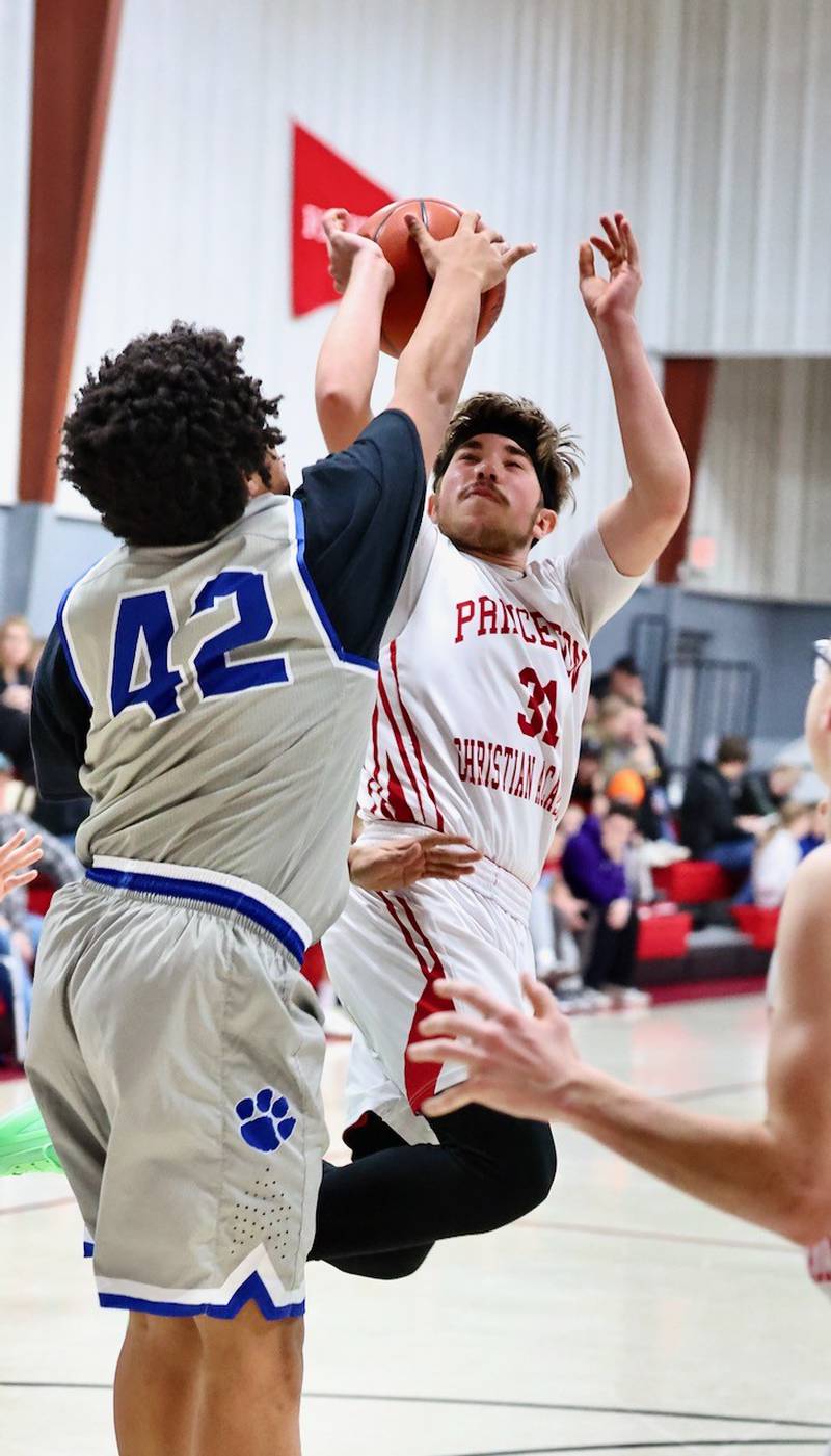 PCA's Jed Johns shoots against Princeton's James Ramono in Thursday's JV game at Howard Hoffman Memorial Gymnasium.