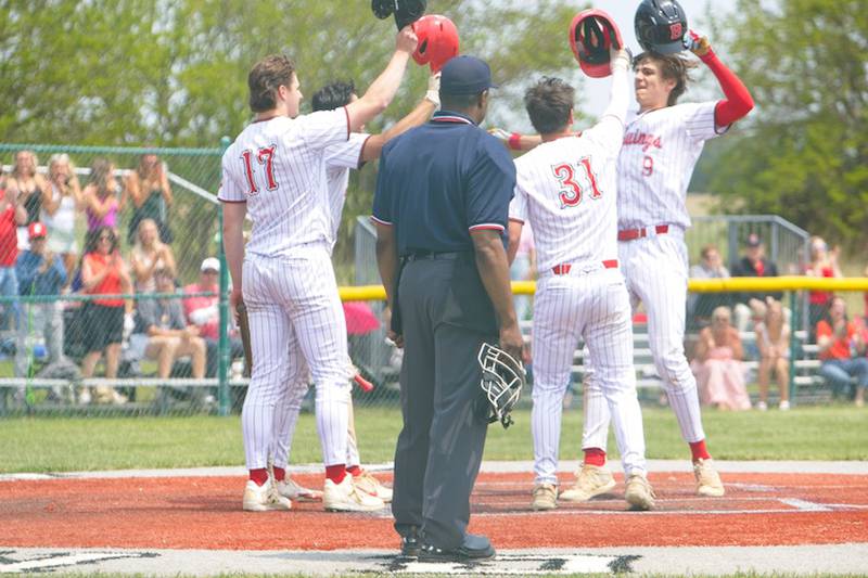 Benet's Quinn Rooney (9) is greeted at home plate after homering against Kaneland at the Class 3A Kaneland Regional Final on Saturday, May 31, 2025 in Maple Park.