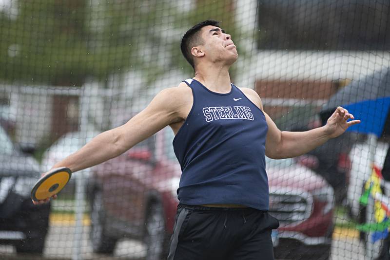 Sterling's Alejandro Arellano throws the disk Friday, April 29, 2022 at the Sterling Night Relays.