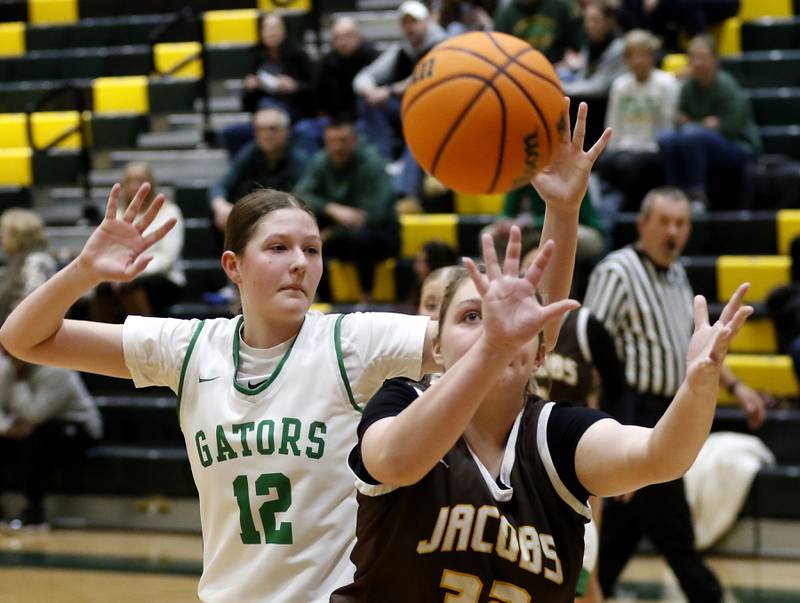 Jacobs' Olivia Schuldt catches a pass in front of Crystal Lake South's Gaby Dzik during a Fox Valley Conference basketball game on Friday, Jan. 17, 2025, at Crystal Lake South High School.