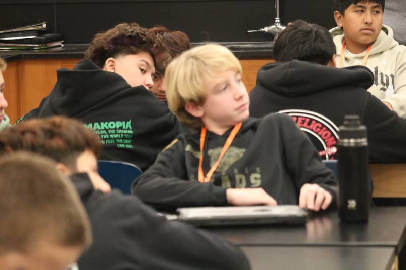 Clinton Rosette Middle School student Everett Hecklesberg (center) raises a question Monday, Nov. 10, 2025, for Vietnam War veteran Edward Higgins during his visit to one of the classrooms at Clinton Rosette Middle School in DeKalb.