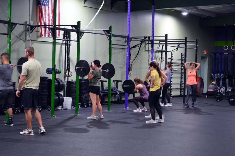 People lift weights as part of a CrossFit class at Westwood Fitness & Sports Center on Tuesday, Nov. 21, 2023. Westwood is one of the Sterling Park District's many parks and facilities.
