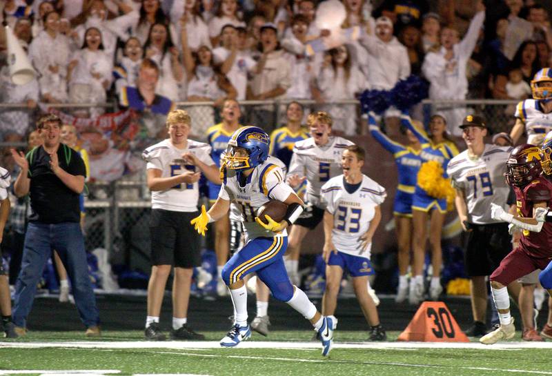 Johnsburg’s Ryan Franze heads for the end zone on a touchdown run in varsity football action on at Richmond-Burton High School in Richmond.