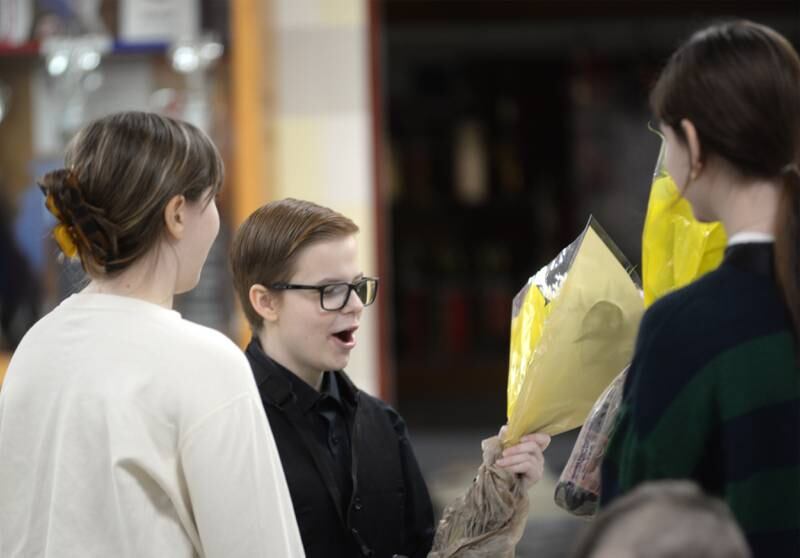 Rileigh Wren reacts as she receives flowers from two of her high school band mates, Kaitlyn Moore and Claire Robers, after her performance with the Clinton Symphony Orchestra during the Family Concert on Sunday, Feb. 23, 2025 in the Morrison High School Auditorium.