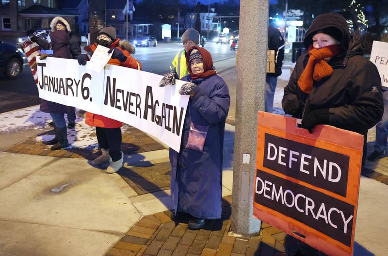 Members of Responsive Engagement Activating Civic Talent brave the cold temperatures Friday, Jan. 6, 2023, during a Stand for Democracy demonstration at Memorial Park in downtown DeKalb. The second annual event was held to affirm the attendees commitment to American democracy.