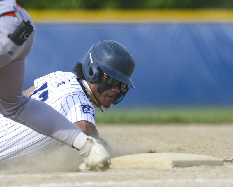 Oswego East's Jacsen Tucker (17) dives back to first during a pickoff attempt in their baseball game versus Oswego. Monday, May 19, 2025 in Oswego.