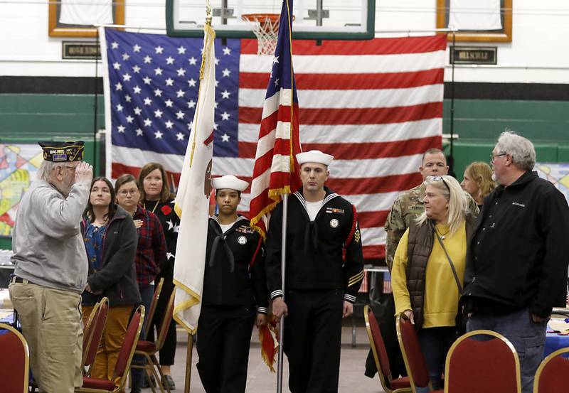 Kaleny Diaz and Cortland Stewart of the U.S. Navy carry the colors into gym for the Veterans Day ceremony on Wednesday, Nov.8, 2023, at Alden-Hebron High School in Hebron.
