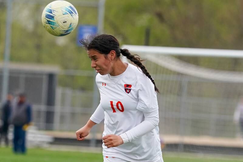 Oswego’s Natasha Lopez (10) plays the ball off a header against Oswego East during a soccer match at Oswego East High School on Tuesday, April 23, 2024.