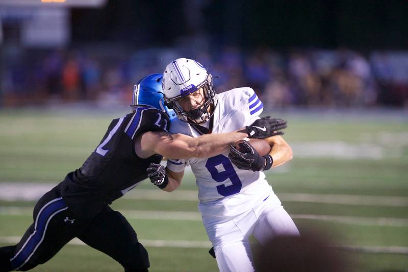 Geneva's Tate Beran is tackled by St. Charles North's Josh Wilkerson on Sept. 12, 2025 in St. Charles.