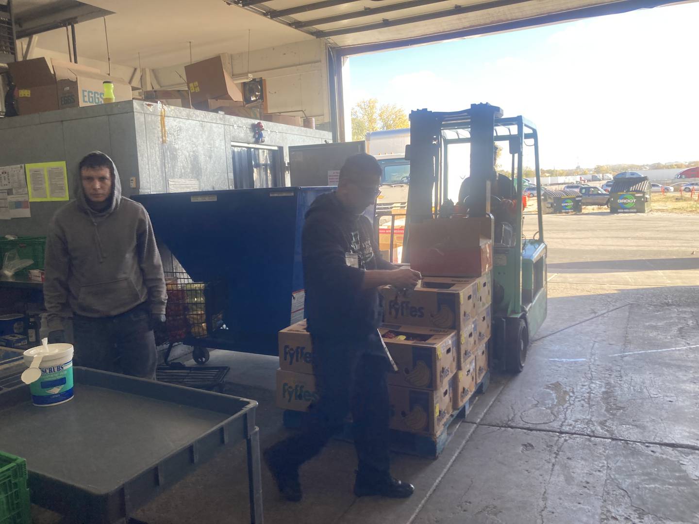 DuPage Township Food Pantry volunteers bring donated food into their warehouse for sorting. 
Thursday, Oct. 30, 2025.