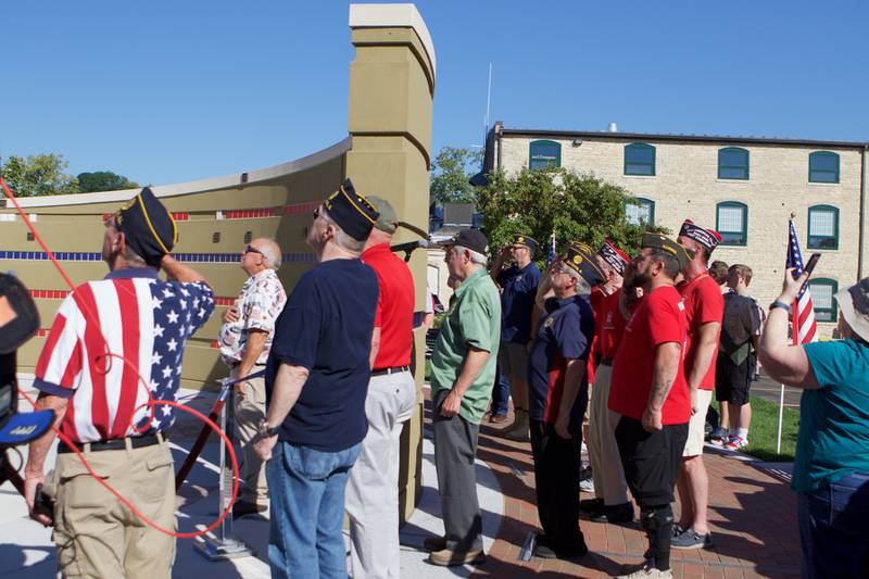 Veteran's salute the flag as it is raised at the Flag Day Monument opening ceremony's at Patriot's Park on Sunday, Oct 1,2023 in Batavia.