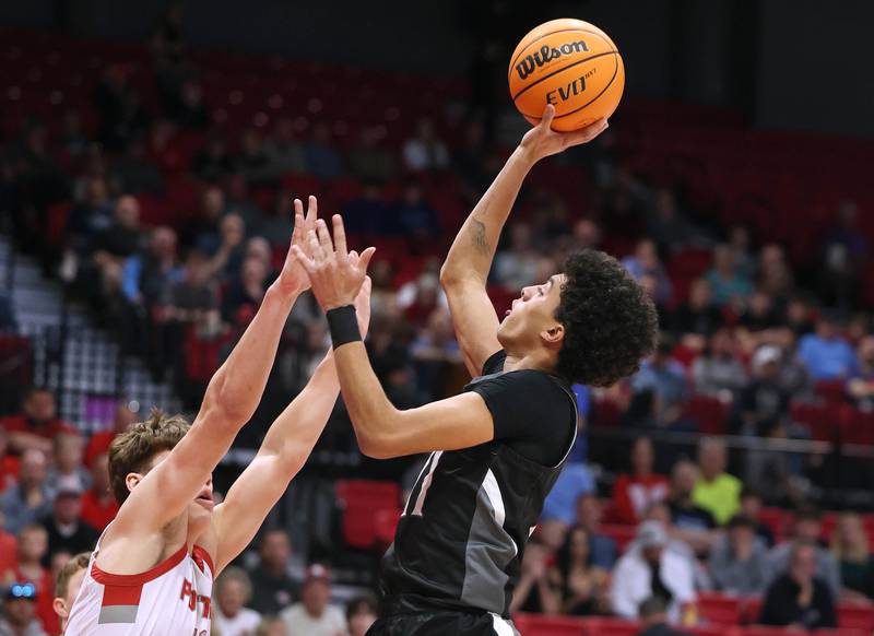 Kaneland's Evan Frieders shoots over Morton's Silas Steffen Monday, March 9, 2026, during their IHSA Class 3A supersectional matchup in the Convocation Center at Northern Illinois University in DeKalb.