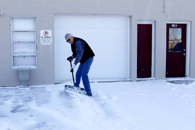 Randy Gillette shovels snow on Thursday, Jan. 23. 2025, at his business, Gillette Concrete Statuary, in Woodstock.