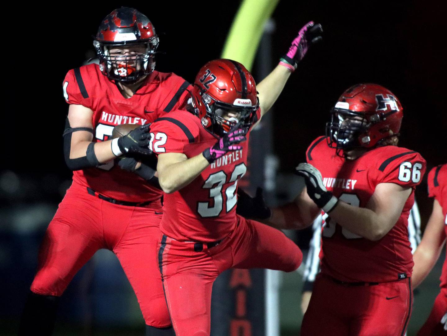 Huntley’s Haiden Janke, left, celebrates after scoring a touchdown with Zach Rios, center,  in Class 8A  football first-round playoff action against Andrew at Huntley on Friday.