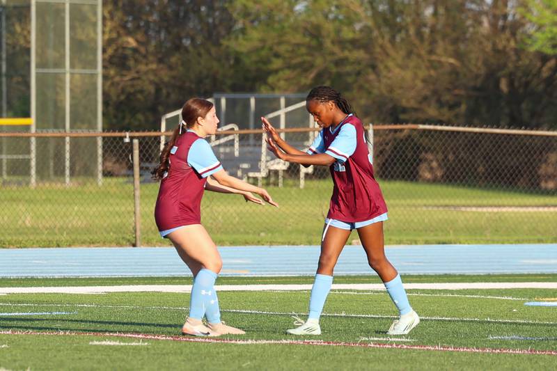 Kankakee's Alina Mkhwanazi, right, celebrates a goal with teammates during Kankakee's 8-4 victory over Beecher on Wednesday, April 22, 2026. Mkhwanazi tallied six goals for the Kays in their win in Southland Athletic Conference play.