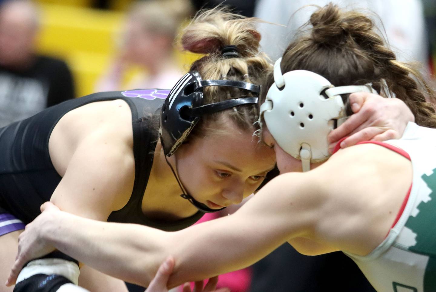 Hampshire’s Amelia Nidelea-Polanin, left, battles Glenbard West’s Karolina Konopka at 120 pounds in the title bout of  varsity girls IHSA Sectional wrestling on Saturday, February 14, 2026, at Schaumburg High School in Schaumburg.