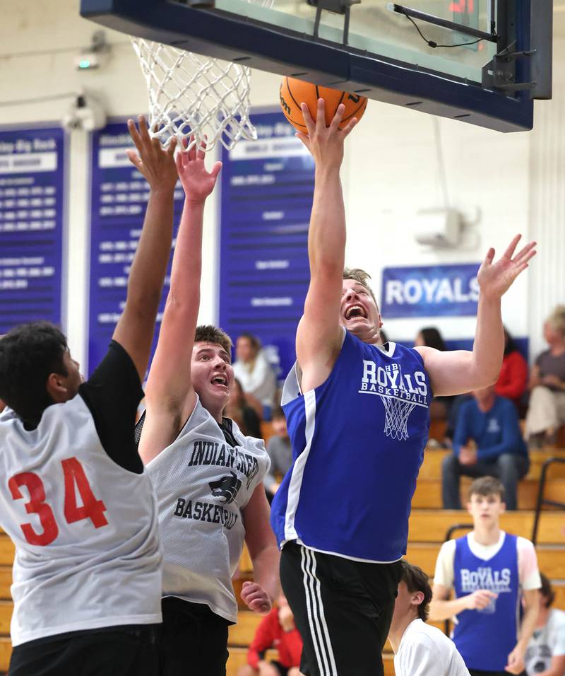 Hinckley Big Rock’s Luke Badal goes to the basket in front of two Indian Creek defenders Monday, June 9, 2025, during their summer game at Hinckley-Big Rock High School.