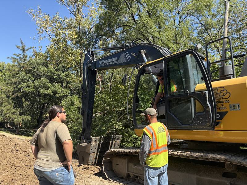 Construction workers review plans on-site at the Kelly Street Bridge project on Monday, Sept. 15, 2025.