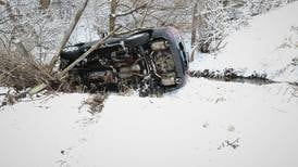 Car rolls down embankment amid heavy snow near Harvard