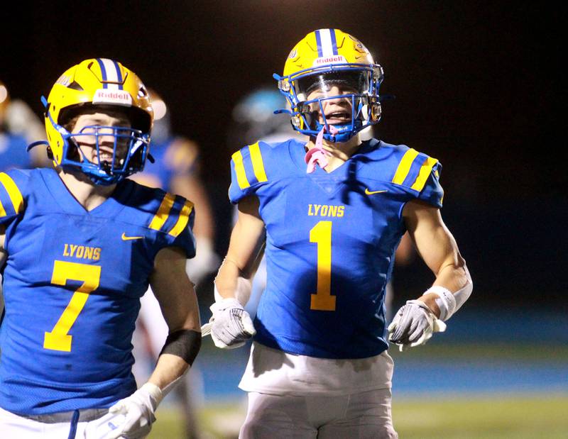 Lyons Township’s Mack Long (right) and Danny Carroll (left) run off the field after Long’s touchdown during the Class 8A second-round game against Downers Grove South on Friday, Nov. 8, 2024 at Lyons Township in Western Springs.