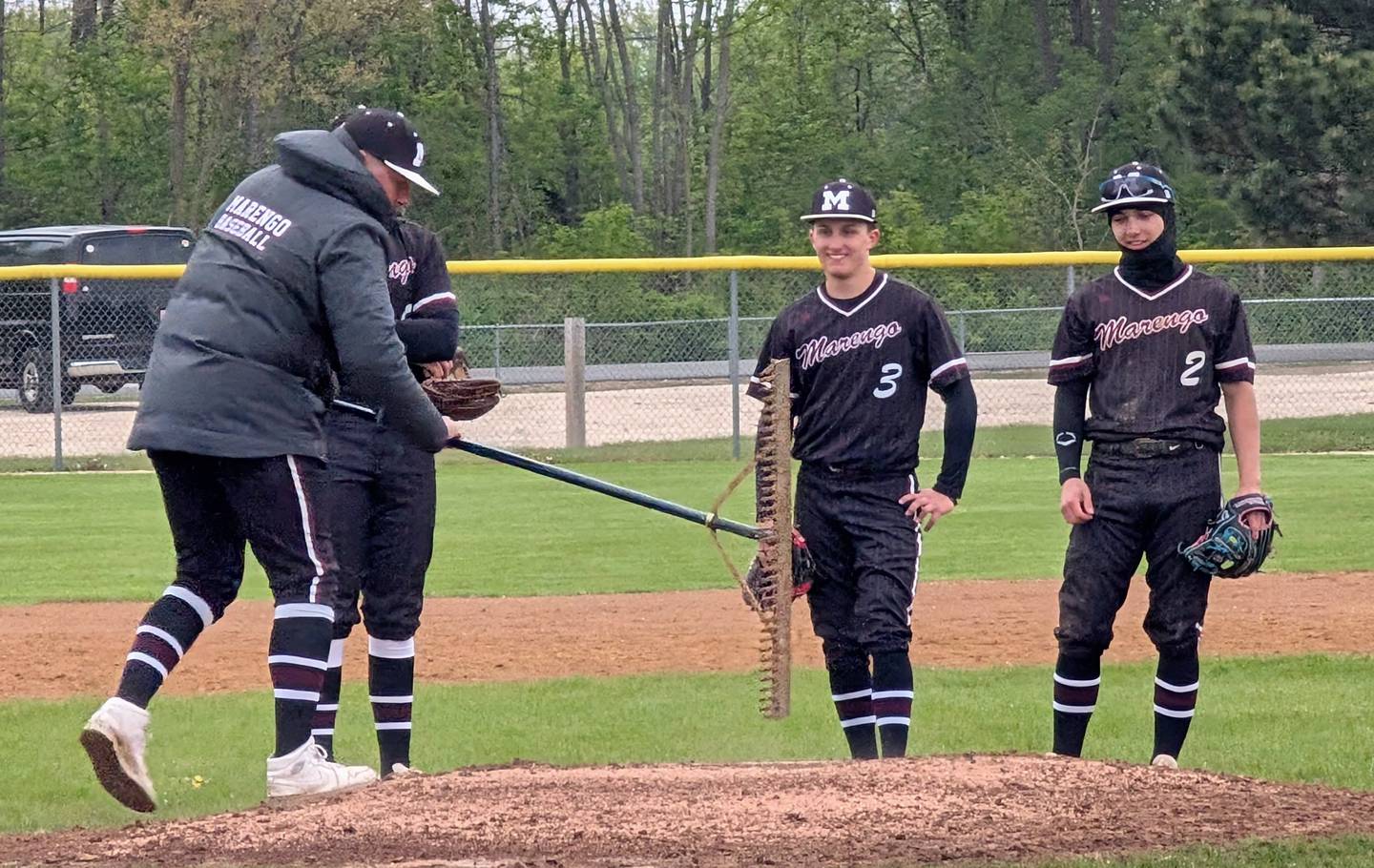 Marengo baseball coach Nick Naranjo rakes the mound in between innings during the Indians' Kishwaukee River Conference game against Richmond-Burton on Thursday, April 30, 2026, in Marengo.