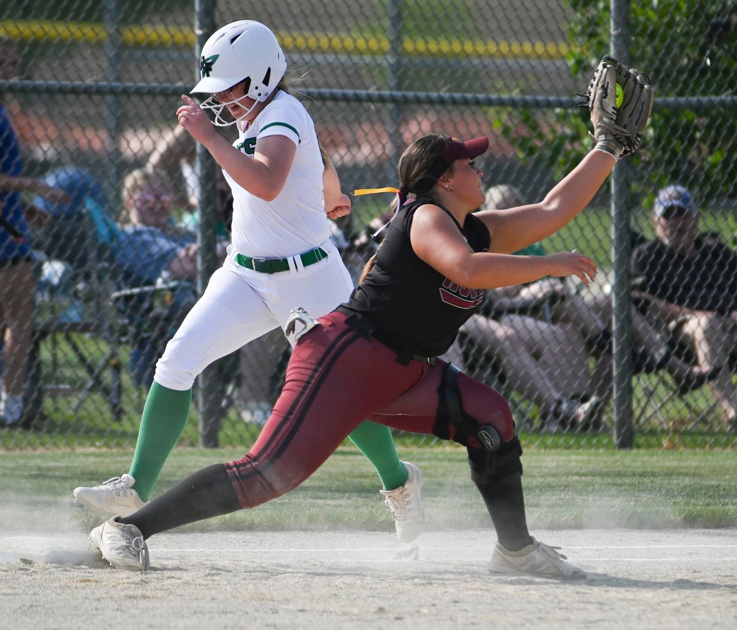 Rock Falls batter Patty Teague hustled down the line but was thrown out at first by inches as Richmond Burton's Norah Spittler squeezes the ball to make the play during sectional semifinal action Tuesday.