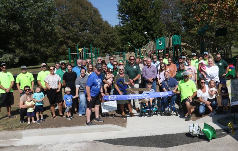 The Princeton Chamber of Commerce, Princeton Park District, friends and community members cuts the ribbon on a new playground dedication on Monday, Sept. 15, 2025 at Zearing Park in Princeton. The 7,000 square-foot playground features sensory panels, in-ground merry-go-round with back support, slides, swings, health development and creative play. Half of the project was paid for by a OSLAD grant and the other half was purchased by the Princeton Park District. No tax dollars were used for the project.