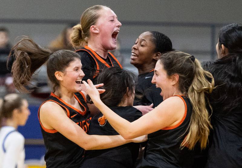 Wheaton Warrenville South’s girls basketball team celebrates their win against Wheaton North on Friday, Dec. 20, 2024.