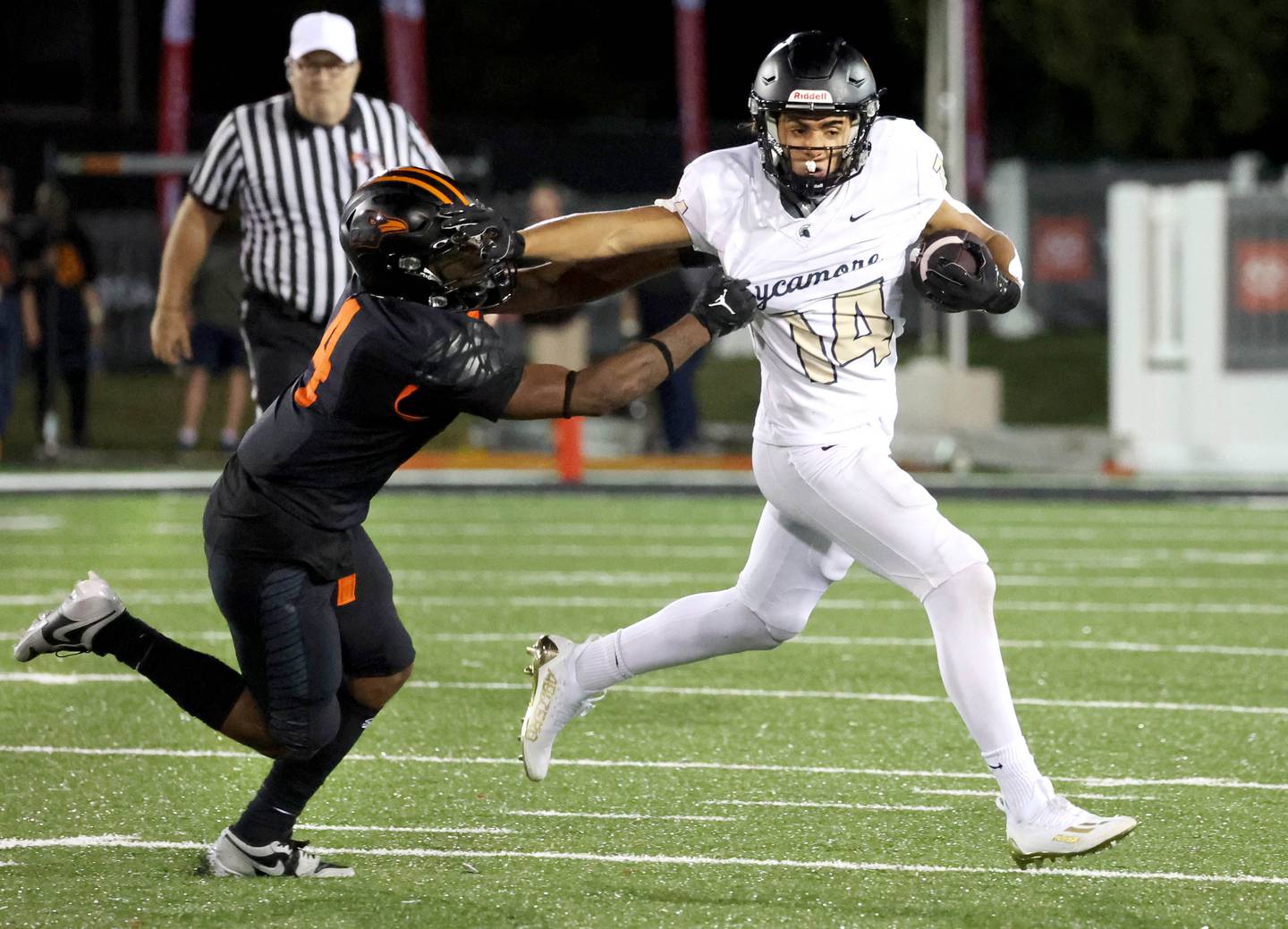 Sycamore's Josiah Mitchell stiff arms DeKalb's Damarrion Belue Friday, Aug. 30, 2024, during the FNBO Challenge at Huskie Stadium at Northern Illinois University.