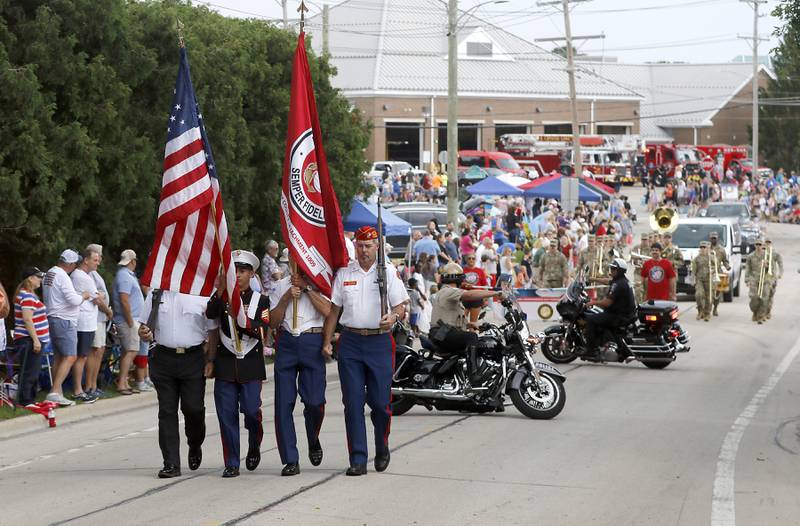 The U.S. Marine Corps Color Guard leads the parade followed by the motorcycle police from various departments on Sunday, July 7, 2024, during Crystal Lake’s annual Independence Day Parade on Dole Avenue in Crystal Lake.