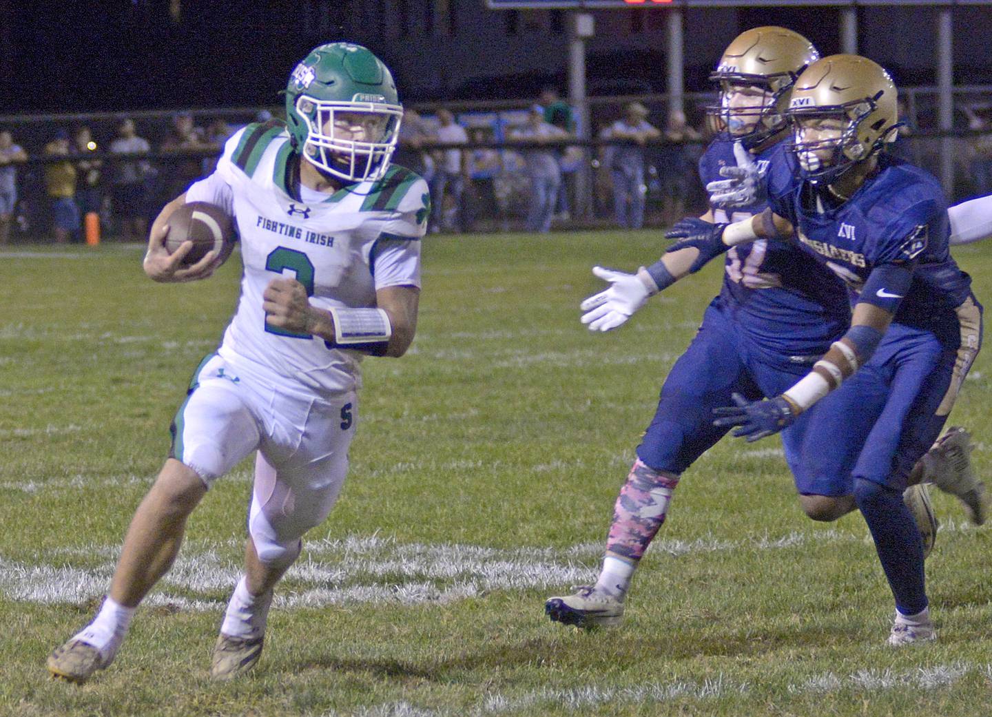 Seneca’s Gunner Varland runs to avoid Marquette’s Grant Dose and Connor Baker in the 2nd quarter Friday at Marquette.