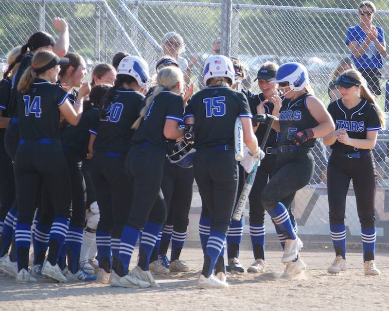 St. Charles North's Jordyn McBride (5) is meet at home plate after hitting a home run against St. Charles East on Wednesday May 14,2025 in St. Charles.