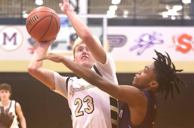 Sycamore's Carter York shoots over Plano's AJ Johnson Tuesday, Jan. 3, 2023, during their game at Sycamore High School.