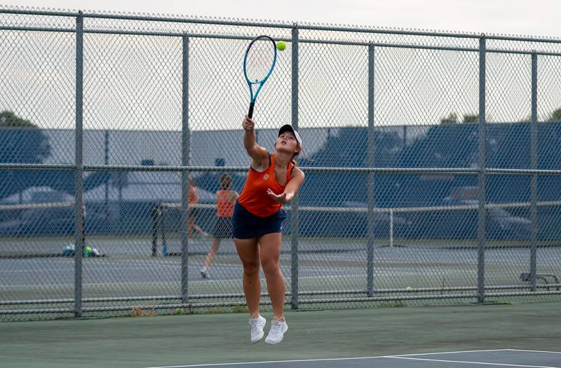 Oswego’s Sofia Carr (8) serves the ball during a doubles tennis match against Oswego East at Oswego High School in Oswego on Thursday, Sep 2, 2021.