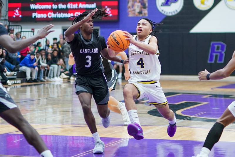 Yorkville Christian's Tray Alford (4) drives to the basket against Kaneland's Marshawn Cocroft (3) during a championship final basketball game in the 61st annual Plano Christmas Classic at Plano High School on Saturday, December 28, 2024.
