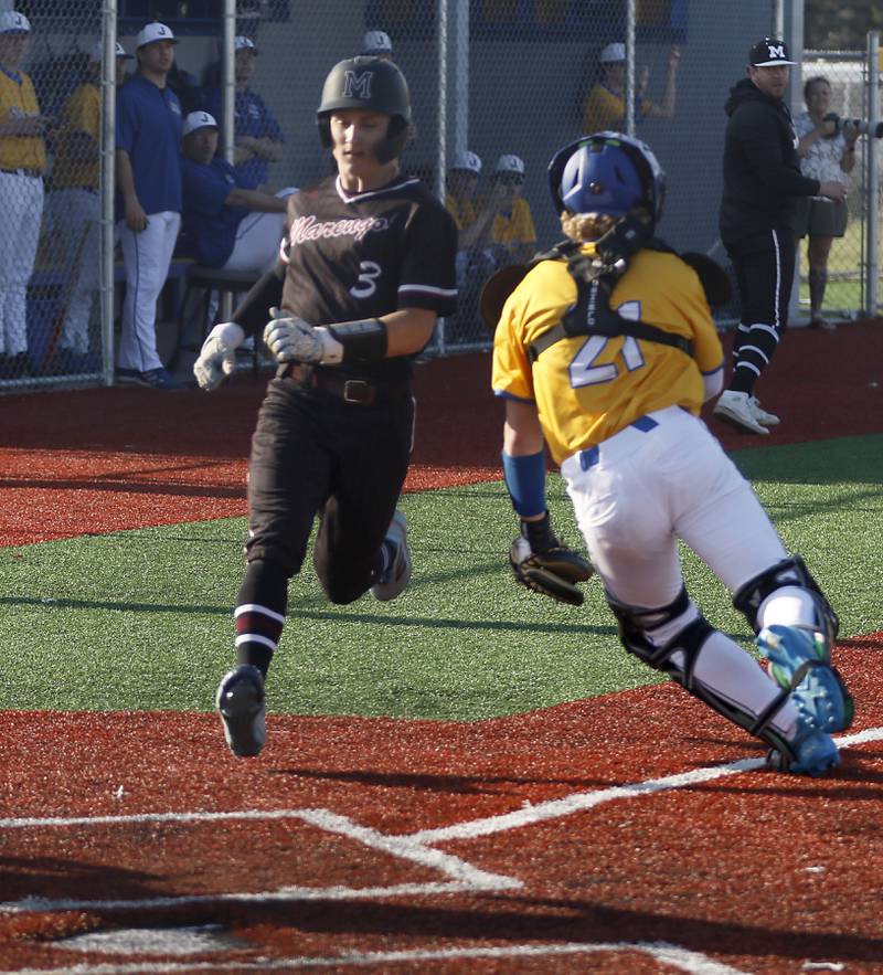 Marengo's Max Broughton runs home to score as Johnsburg's Jack Thompson chases down the throw during a Kishwaukee River Conference baseball game on Wednesday, April 22,2026, at Johnsburg High School.