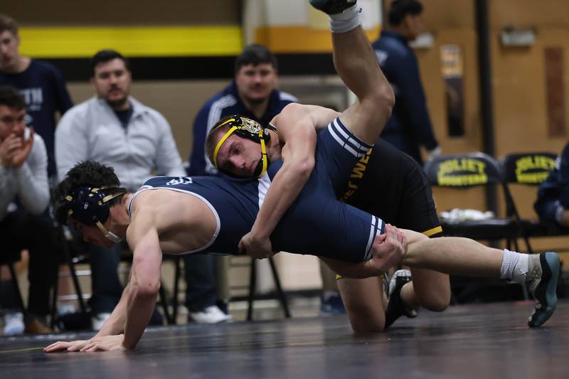 Joliet West’s Tristan Radeke drops Plainfield South’s Erik Schmidt in the 165 pound match on Wednesday, Dec. 3, 2025 in Joliet.
