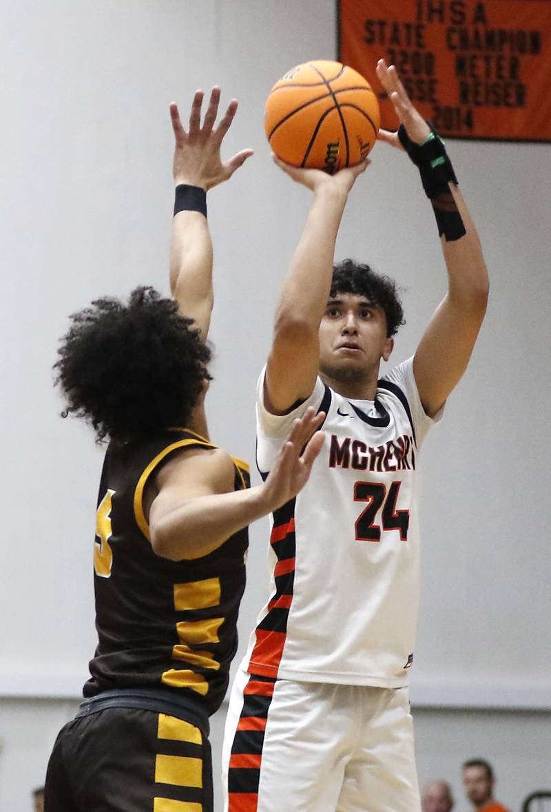 McHenry's Adam Anwar shoots the ball over Jacobs' Jordan O'connor during an IHSA Class 4A McHenry Regional basketball game on Wednesday, Feb. 26, 2025, at McHenry High School.