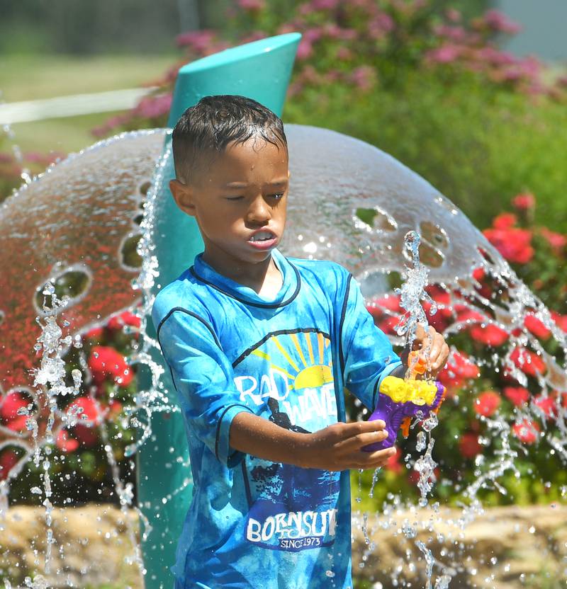 Kalex Yarber, 6, of Denver, Colorado, fills a water pistol at the Dixon Park District's Water Wonderland Splash Pad on Tuesday afternoon. Kalex's mom, Nikki (nee Hollis), grew up in Dixon and was visiting family when the 90-degree temps called for an outing to the splash pad.
