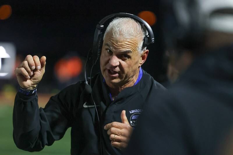 Lincoln-Way East Rob Zvonar talks to a coach on the sidelines during the game against Minooka on Friday, Nov. 8, 2024 in Minooka.